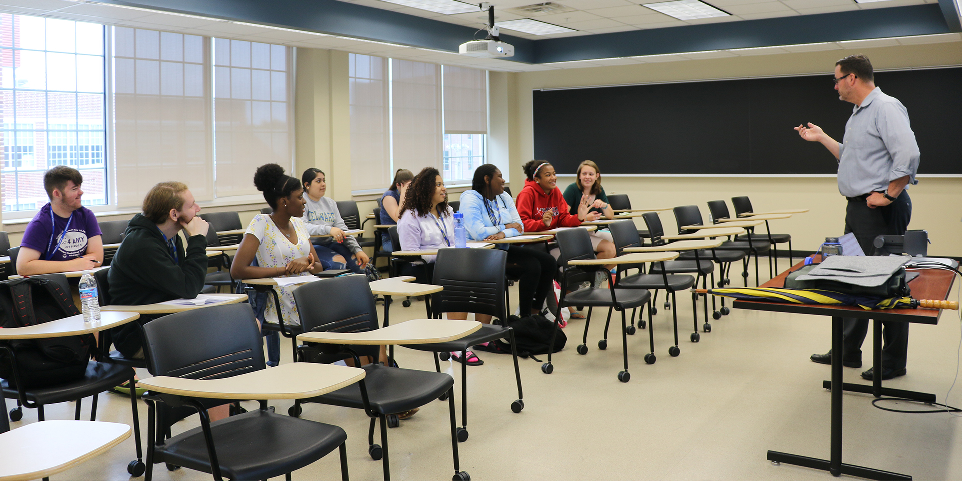 Teacher speaks to high school students in classroom