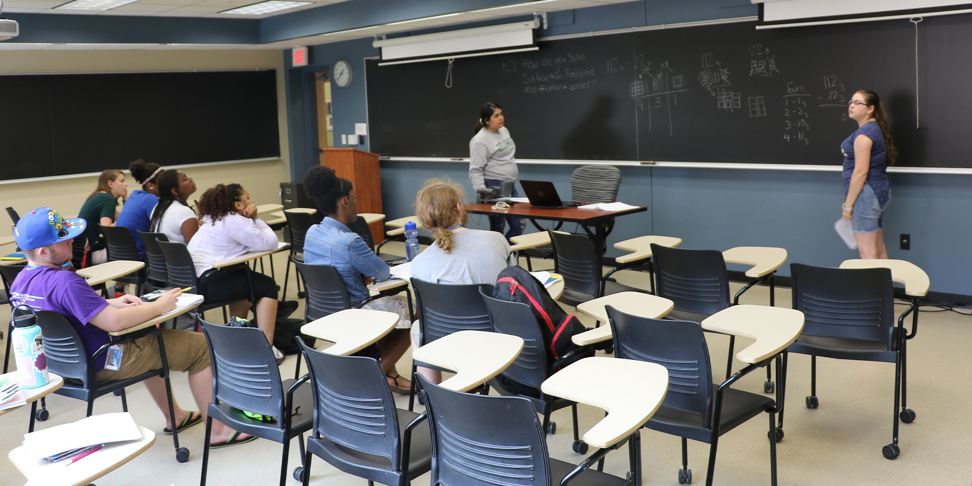 Teacher speaks to high school students in classroom